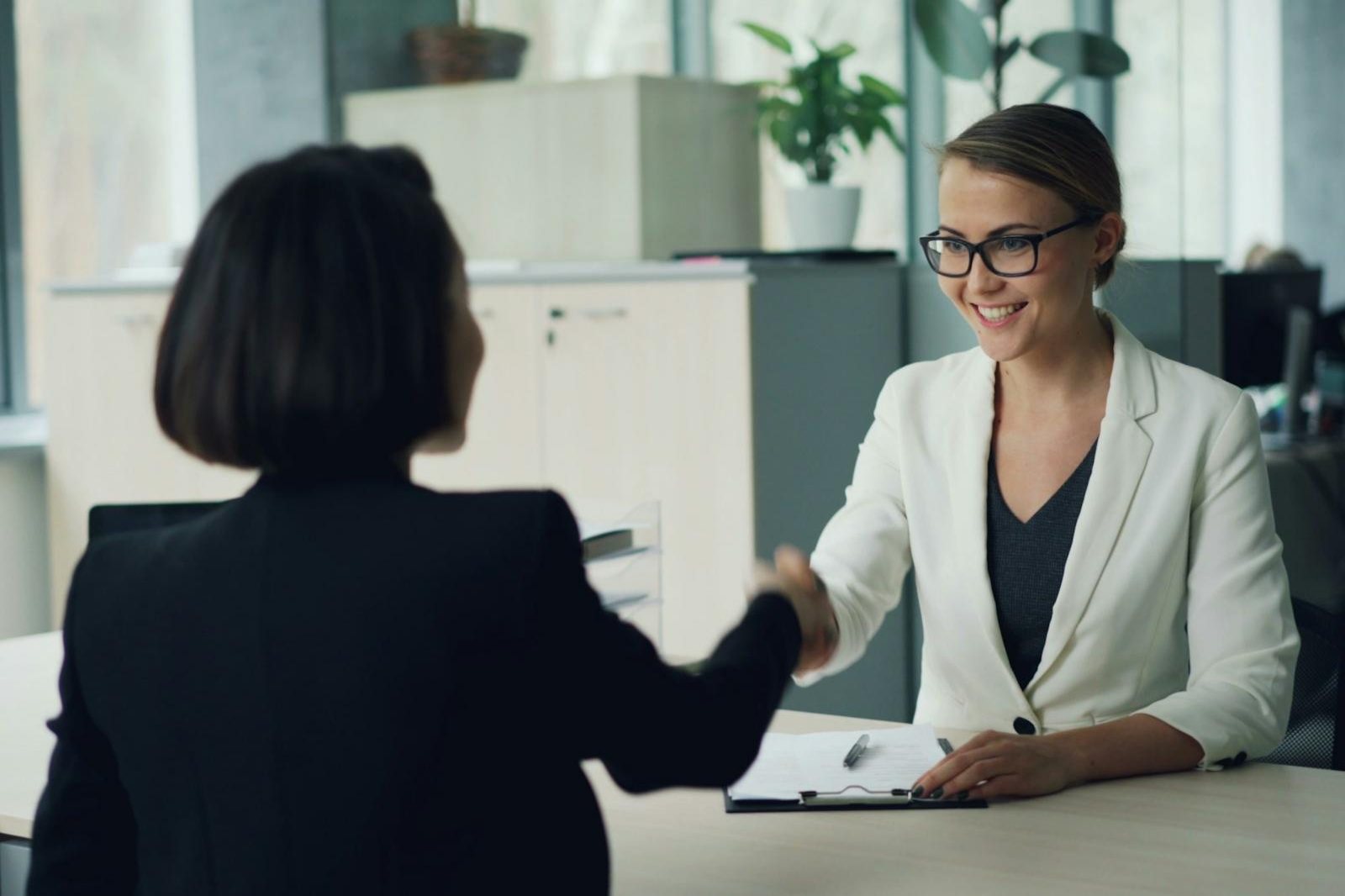 Financial advisor welcoming a client with a handshake